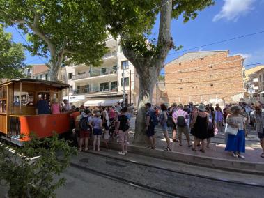 Un gran nombre de turistes esperen a l’aturada del tramvia, al Port.