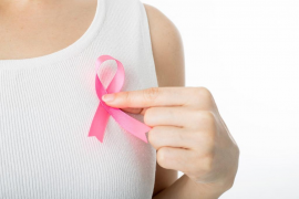 Pink Breast cancer awareness ribbon holding by woman who need to show healthcare concept.