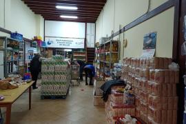 El Grup d’Acció Socials col·loca els aliments a les prestatgeries de la seu.